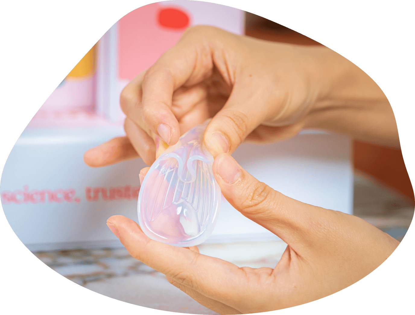 woman pinches fertility aid Sperm Guideβs flap to form U-shape