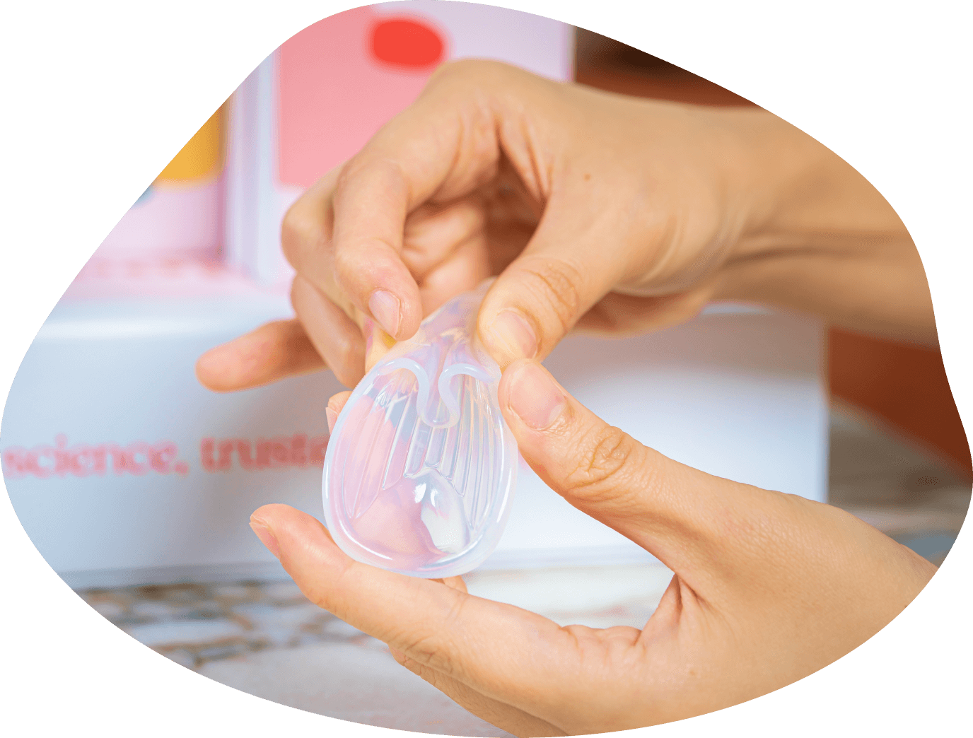 woman pinches fertility aid Sperm Guide’s flap to form U-shape