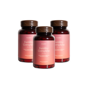 Three bottles of 'Fertility Complete for Her' supplements with a pink label on a white background.
