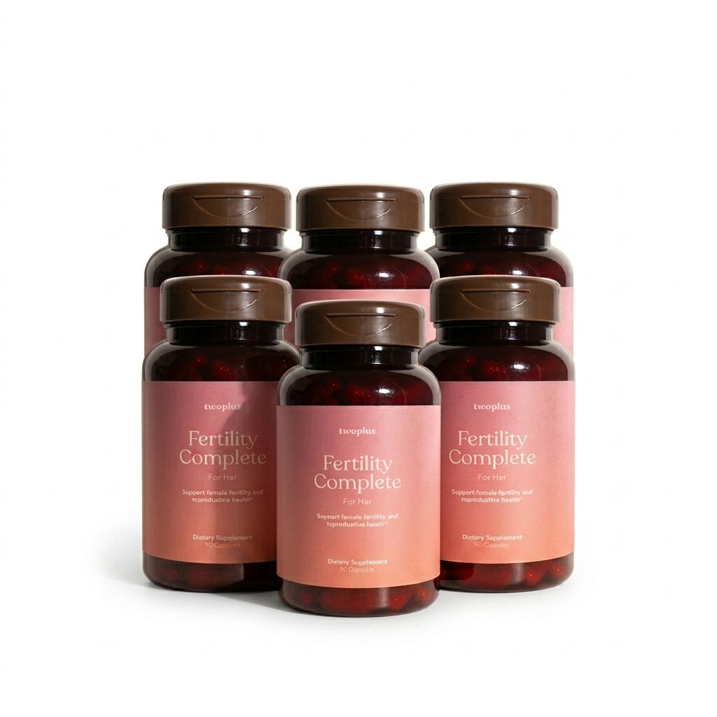 Six bottles of 'Fertility Complete for Her' supplement on a white background