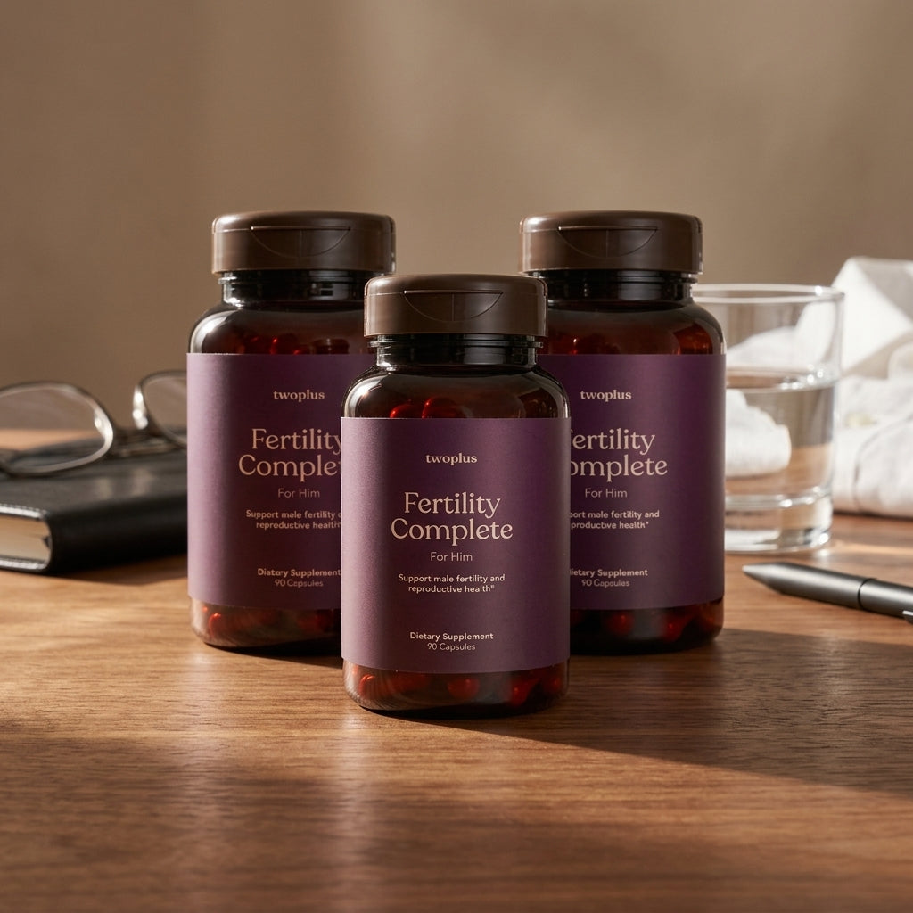 Three bottles of 'Fertility Complete for Him' supplements on a wooden surface with a neutral background.
