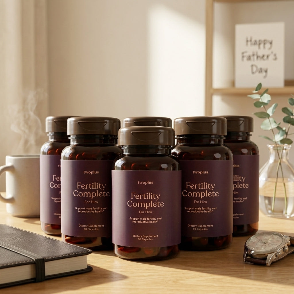Six Bottles of 'Fertility Complete for Him' supplements on a wooden desk, watch and notebook in front, and a happy father's day card behind.