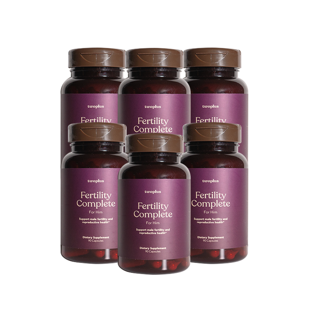 Six bottles of 'Fertility Complete for Him' supplements by twoplus Fertility, with a purple label on a white background